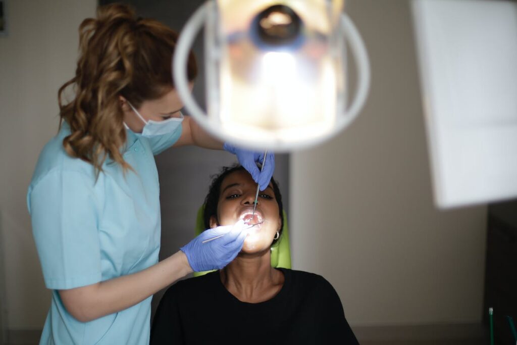 Dentist curing teeth of black patient