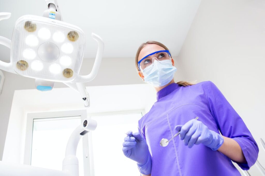 Woman dentist in uniform with dental instrumentation
