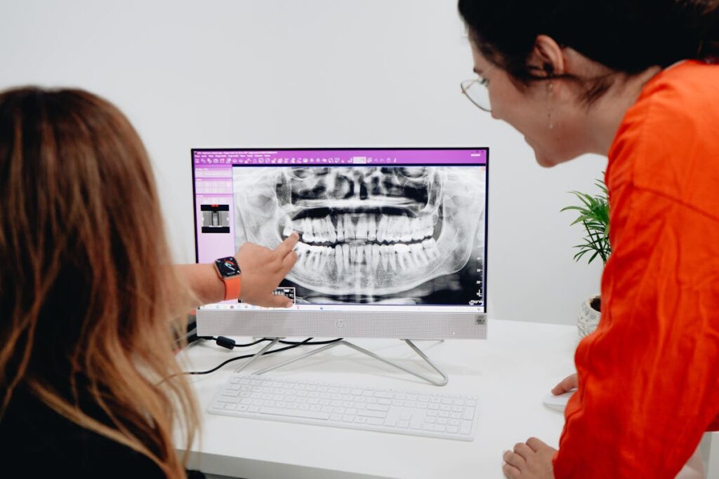 Women Looking at a Dental X-ray on a Computer
