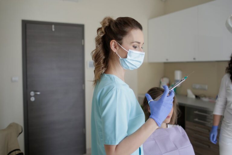 Woman in Teal Scrub Suit Holding Injection