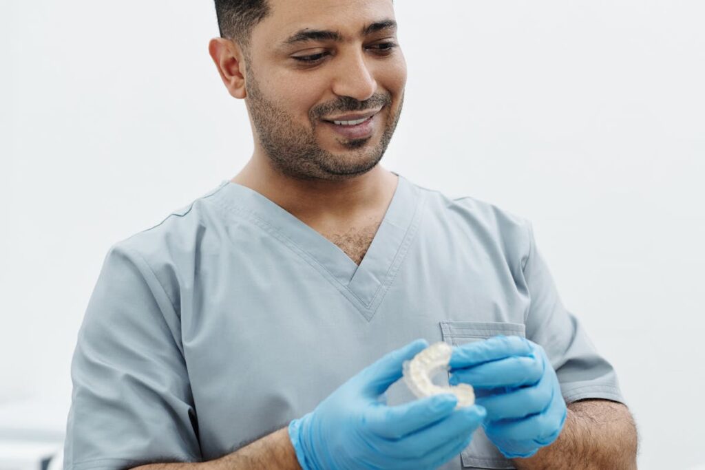 A Man in Gray Scrub Suit with Latex Gloves