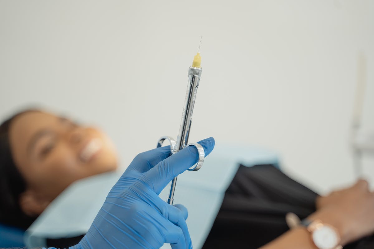 A Person Holding a Dental Syringe