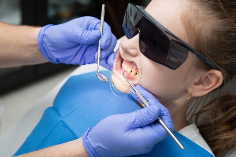 A Dentist Checking the Girl's Teeth